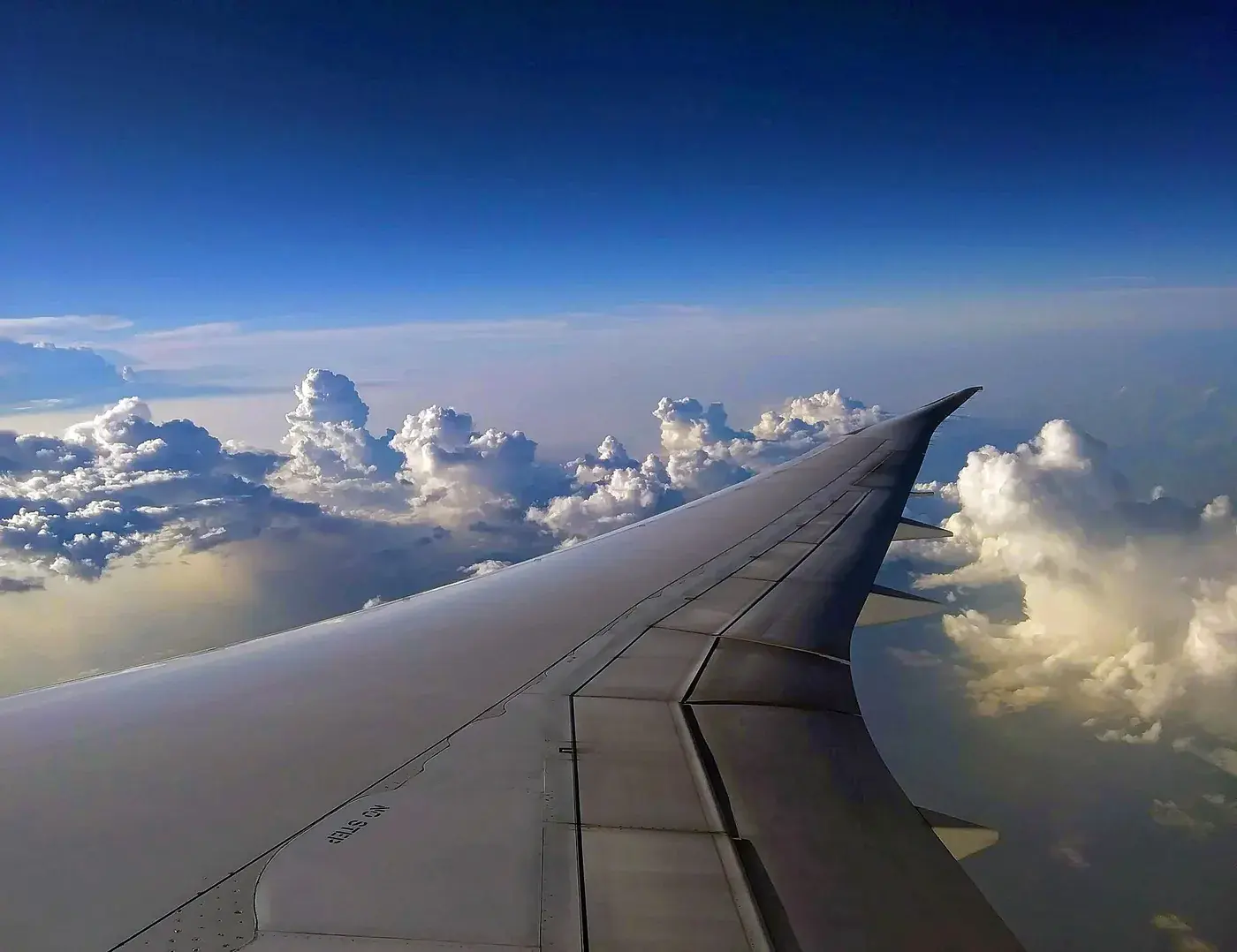 Aircraft window view above the clouds on the way to New Zealand